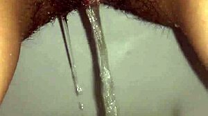 Slender Brunette Pisses in Panties During Wet Shower Scene