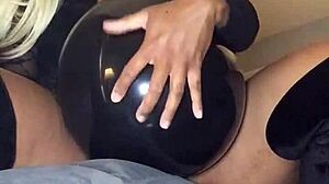 She indulges in wild balloon fetish with dominant flair.