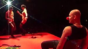 these skinny oiled lesbians lick each other with toys on the public stage