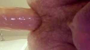 gay guy attempts to insert large dildo into his ass