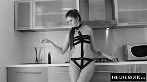 Skinny redhead applies oil and masturbates in the kitchen