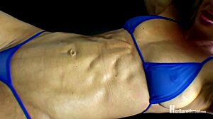 muscular babe flexes in tiny bikini thong