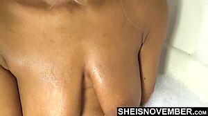 Innocent black girl MsNovember washes big natural boobs in bath