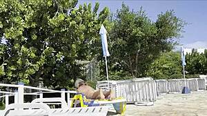 She spots guy jerking by public pool and gives handjob to help him cum outdoors