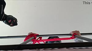 Bound in latex, she takes cock down throat