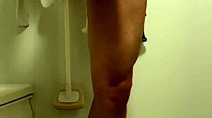 Muscular handsome guy pees uncontrollably in shower.