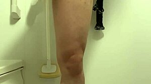 Muscular handsome guy pees uncontrollably in shower.