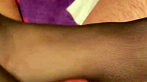 Wife gives husband footjob in black reinforced toe stockings, leading to cumshot.