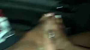 Ebony gives sensual footjob to big cock