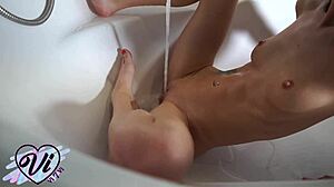 teen touches herself in bathroom under running water