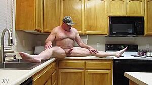 Person stands naked in the kitchen preparing breakfast