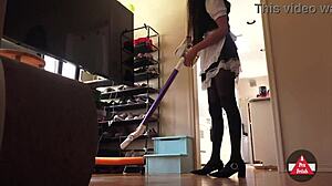 French maid in stockings vacuums the house