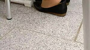 In this fetish video, she engages in shoeplay with tan nylons and flats.