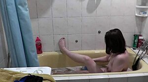 What makes this beautiful cute girl take a soapy bath, showing wet pussy and natural tits in the bathroom?