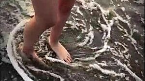 public sex on mexican beach with petite latina babe giving handjob and blowjob to muscular stud's monster cock.