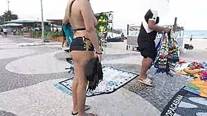 Wearing mini shorts in Copacabana, blonde Latina milf draws stares from guys on the beach.