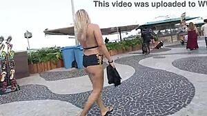 Wearing mini shorts in Copacabana, blonde Latina milf draws stares from guys on the beach.
