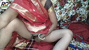 Indian wife in red saree and black blouse gets boobs squeezed by husband. He fingers her hairy pussy before rough ass fucking with hindi audio.