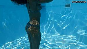 Hey there, beautiful big breasted Angelica Heart in bikini by the pool with her friend.