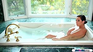 Asian teen rubs her roommate's beaver in the bathroom tub