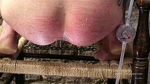 Kneeling babe stretched by syringe enema deep in ass!